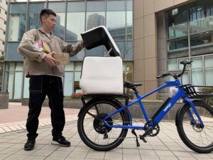 A courier packs his keego kg2 delivery ebike