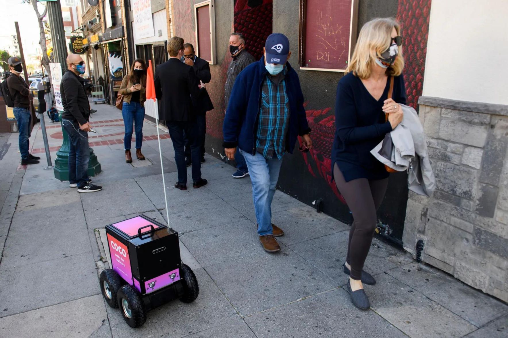 Sideway delivery robot working on the sidewalk.